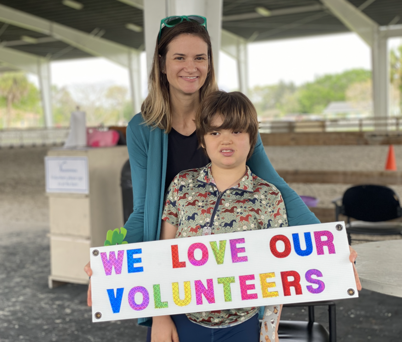 One of our riders and his mother show their love for the volunteers at Vinceremos!